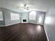 Bright living room with fireplace, ceiling fan, wood floors, and a front door with an arched window at 3647 Diamond Cir, Decatur, GA 30034