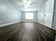 Large living room with neutral paint, wood flooring, a window, and a ceiling fan with light at 3647 Diamond Cir, Decatur, GA 30034