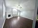 Bright living room with fireplace, ceiling fan, wood floors, and a front door with an arched window at 3647 Diamond Cir, Decatur, GA 30034