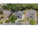 Aerial view shows a well-maintained home with a lush, green yard and mature trees at 5293 Aldeburgh Dr, Suwanee, GA 30024