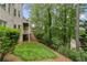 The beautiful backyard showcases a multi-level deck and lush greenery at 5293 Aldeburgh Dr, Suwanee, GA 30024