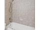 Bathroom features a tiled wall and a tub and shower combination at 5293 Aldeburgh Dr, Suwanee, GA 30024