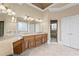 Main bathroom featuring double vanities, large mirrors, stained glass window, tile flooring, and glass enclosed shower at 5293 Aldeburgh Dr, Suwanee, GA 30024
