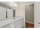 Bathroom features a long vanity, large mirror and access to linen closet at 5293 Aldeburgh Dr, Suwanee, GA 30024