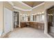 Spacious main bathroom with tile floors, double vanities, decorative windows, and glass enclosed shower at 5293 Aldeburgh Dr, Suwanee, GA 30024