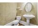Powder room featuring pedestal sink, oval mirror, sconces, toilet, and wood look flooring at 5293 Aldeburgh Dr, Suwanee, GA 30024