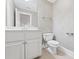 Stylish bathroom with a white vanity, modern fixtures, neutral paint, and tile flooring at 5293 Aldeburgh Dr, Suwanee, GA 30024