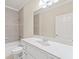 Bathroom features a large mirror over a white vanity and tiled shower/tub at 5293 Aldeburgh Dr, Suwanee, GA 30024