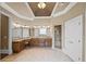 Bright bathroom with tile floors, double vanities, decorative ceiling, decorative window, and glass enclosed shower at 5293 Aldeburgh Dr, Suwanee, GA 30024