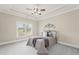 Charming bedroom features a decorative accent and a queen-size bed at 5293 Aldeburgh Dr, Suwanee, GA 30024