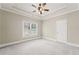 Spacious bedroom with neutral walls, tray ceiling and ceiling fan at 5293 Aldeburgh Dr, Suwanee, GA 30024