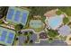 Aerial view showcasing tennis courts, a basketball court, and a community pool, offering a variety of activities at 5293 Aldeburgh Dr, Suwanee, GA 30024