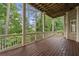 Enjoy backyard nature views from this second story deck featuring light-colored wood and white railings at 5293 Aldeburgh Dr, Suwanee, GA 30024