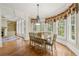 Elegant dining area with large windows offering panoramic views of the surrounding landscape at 5293 Aldeburgh Dr, Suwanee, GA 30024
