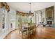Sun-drenched dining area featuring a fireplace and views of the property at 5293 Aldeburgh Dr, Suwanee, GA 30024