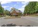 View of the secure entrance to the gated community on a sunny day at 5293 Aldeburgh Dr, Suwanee, GA 30024