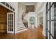 Grand foyer showcasing hardwood floors, staircase, and elegant architectural details with lots of natural light at 5293 Aldeburgh Dr, Suwanee, GA 30024