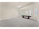 Large game room with recessed lights, a ceiling fan, multiple windows, and a shuffleboard table at 5293 Aldeburgh Dr, Suwanee, GA 30024