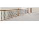 Upstairs hallway features wood and iron railing and neutral walls at 5293 Aldeburgh Dr, Suwanee, GA 30024