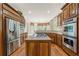 Updated kitchen with stainless steel appliances, granite countertops, and custom cabinetry at 5293 Aldeburgh Dr, Suwanee, GA 30024