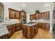 Well-equipped kitchen with stainless steel appliances, custom wood cabinets, and granite island at 5293 Aldeburgh Dr, Suwanee, GA 30024
