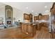 Spacious open kitchen with custom wood cabinets and granite countertops, flowing into living space at 5293 Aldeburgh Dr, Suwanee, GA 30024