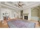 Spacious living room with coffered ceilings, fireplace, built-ins, and seamless transition to the dining area at 5293 Aldeburgh Dr, Suwanee, GA 30024
