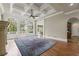 Bright living room with coffered ceilings, large arched windows, fireplace, and hardwood floors at 5293 Aldeburgh Dr, Suwanee, GA 30024