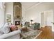 Inviting living room featuring a stone fireplace, high ceilings, and plush seating arrangements at 5293 Aldeburgh Dr, Suwanee, GA 30024