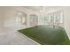 This living room features a putting green and arched doorways for easy access to other parts of the home at 5293 Aldeburgh Dr, Suwanee, GA 30024