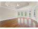 Spacious main bedroom with hardwood floors, tray ceiling, and lots of natural light at 5293 Aldeburgh Dr, Suwanee, GA 30024