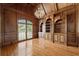This office features wood paneling, a large window, hardwood floors, and built-in bookshelves at 5293 Aldeburgh Dr, Suwanee, GA 30024