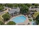 Aerial view of a large community pool with waterslide, clubhouse, playground, and ample seating at 5293 Aldeburgh Dr, Suwanee, GA 30024