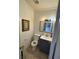 Small bathroom features white subway tile, blue vanity, framed art, and neutral-colored floors at 1151 Rankin St # 2B, Stone Mountain, GA 30083
