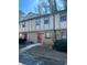 Charming townhouse features a brick facade, red door, and well-maintained landscaping at 1151 Rankin St # 2B, Stone Mountain, GA 30083