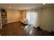 Light filled living room with dark hardwood floors, white sofa, curtains, and built in bookcase at 1151 Rankin St # 2B, Stone Mountain, GA 30083