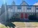 Two-story townhouse featuring dual front doors and classic design, set against a vibrant blue sky at 1151 Rankin St # 7A, Stone Mountain, GA 30083