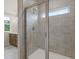 Bathroom shower with tiled walls and glass doors at 1954 William Glen St, Dacula, GA 30019