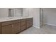 Bathroom vanity with double sinks, drawers, and tile flooring at 1954 William Glen St, Dacula, GA 30019