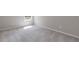 Empty bedroom features a window and neutral carpet at 1954 William Glen St, Dacula, GA 30019