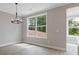 Elegant dining room featuring wood floors, a modern chandelier, and large windows at 1954 William Glen St, Dacula, GA 30019