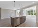 Modern kitchen featuring a central island with stainless steel appliances and hardwood floors at 1954 William Glen St, Dacula, GA 30019