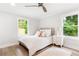 Cozy bedroom with a comfortable bed, neutral decor, and large windows offering plenty of natural light and view of greenery at 2260 Old Spring Se Rd, Smyrna, GA 30080