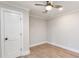 A simple bedroom includes hardwood floors, a ceiling fan, and a door to the closet at 2260 Old Spring Se Rd, Smyrna, GA 30080