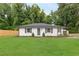 Charming single-story home with a lush green lawn and freshly painted white brick exterior at 2260 Old Spring Se Rd, Smyrna, GA 30080