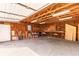 An empty garage features exposed rafters and is equipped with a work bench and shelving at 2260 Old Spring Se Rd, Smyrna, GA 30080