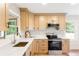 Well-equipped kitchen with modern stainless steel appliances, light wood cabinets, and a bright window overlooking the yard at 2260 Old Spring Se Rd, Smyrna, GA 30080
