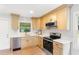 Well-lit kitchen featuring stainless steel appliances, light wood cabinets, and quartz countertops at 2260 Old Spring Se Rd, Smyrna, GA 30080
