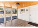 Charming screened porch featuring a wood ceiling, white walls, an exterior door, and a view of the surrounding neighborhood at 2260 Old Spring Se Rd, Smyrna, GA 30080