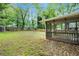 Expansive backyard featuring a wooden shed, grass, mulch and a screened in porch at 2308 Scotty Cir, Decatur, GA 30032